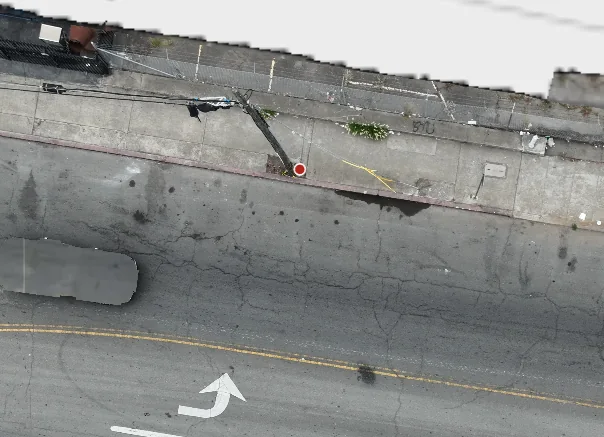 The same street corner on a later flight, the dumped material gone